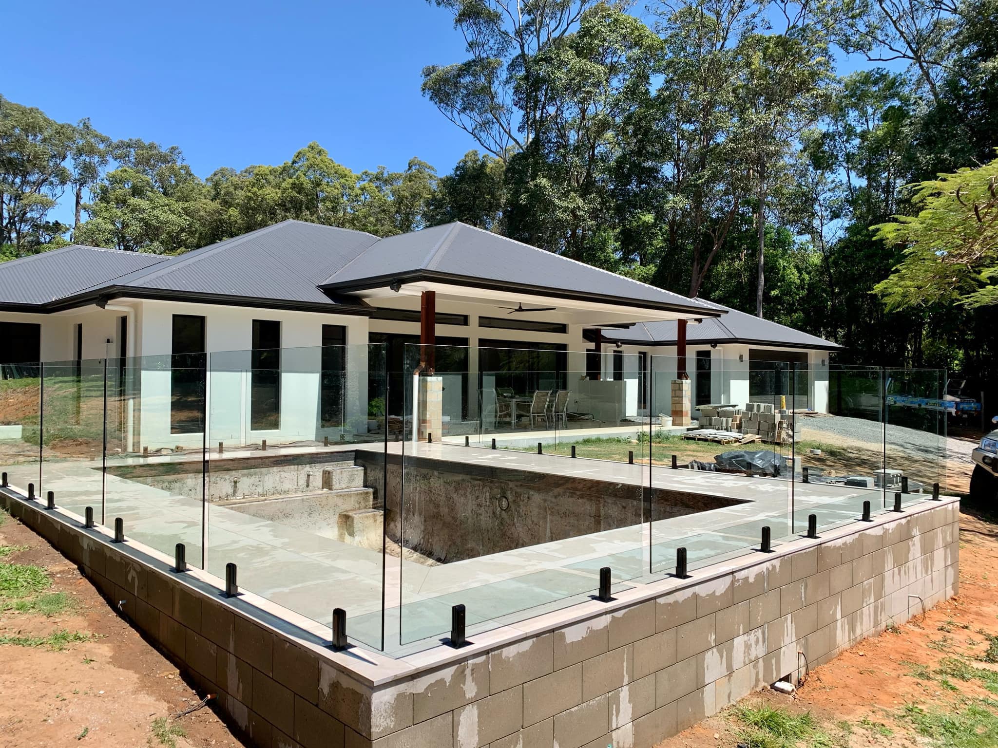 Completed frameless glass pool fence on a Sunshine Coast home